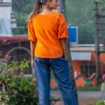 Back view of orange khadi top with puff sleeves and blue cotton trousers from LAVA co-ord set.