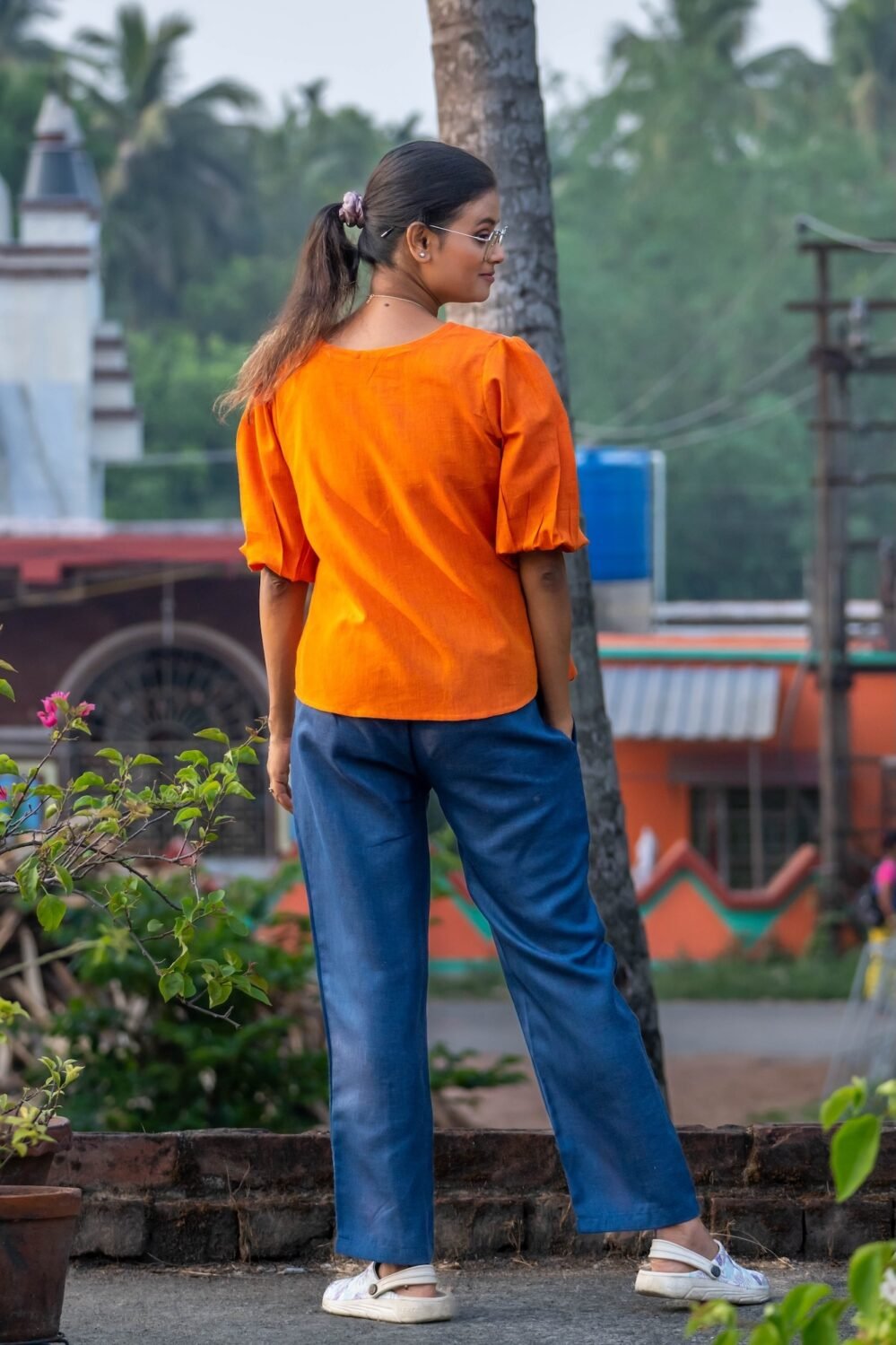 Back view of orange khadi top with puff sleeves and blue cotton trousers from LAVA co-ord set.