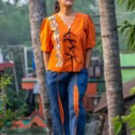 Full length front view of LAVA handpainted co-ord set with orange doori shirt and blue contrast panel pants.