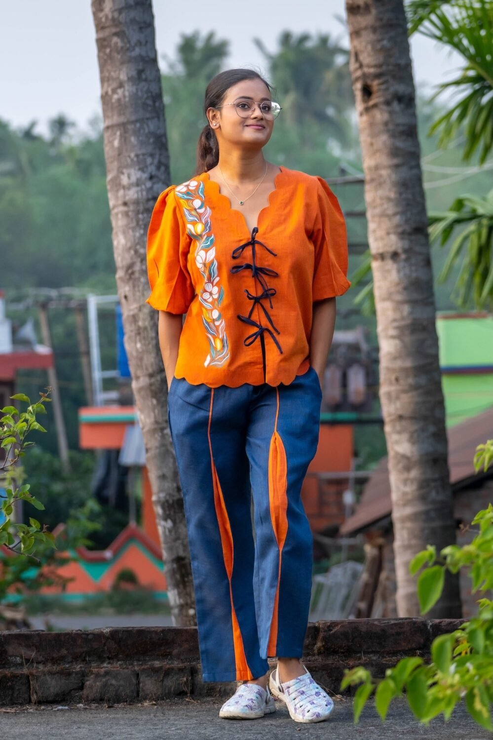 Full length front view of LAVA handpainted co-ord set with orange doori shirt and blue contrast panel pants.