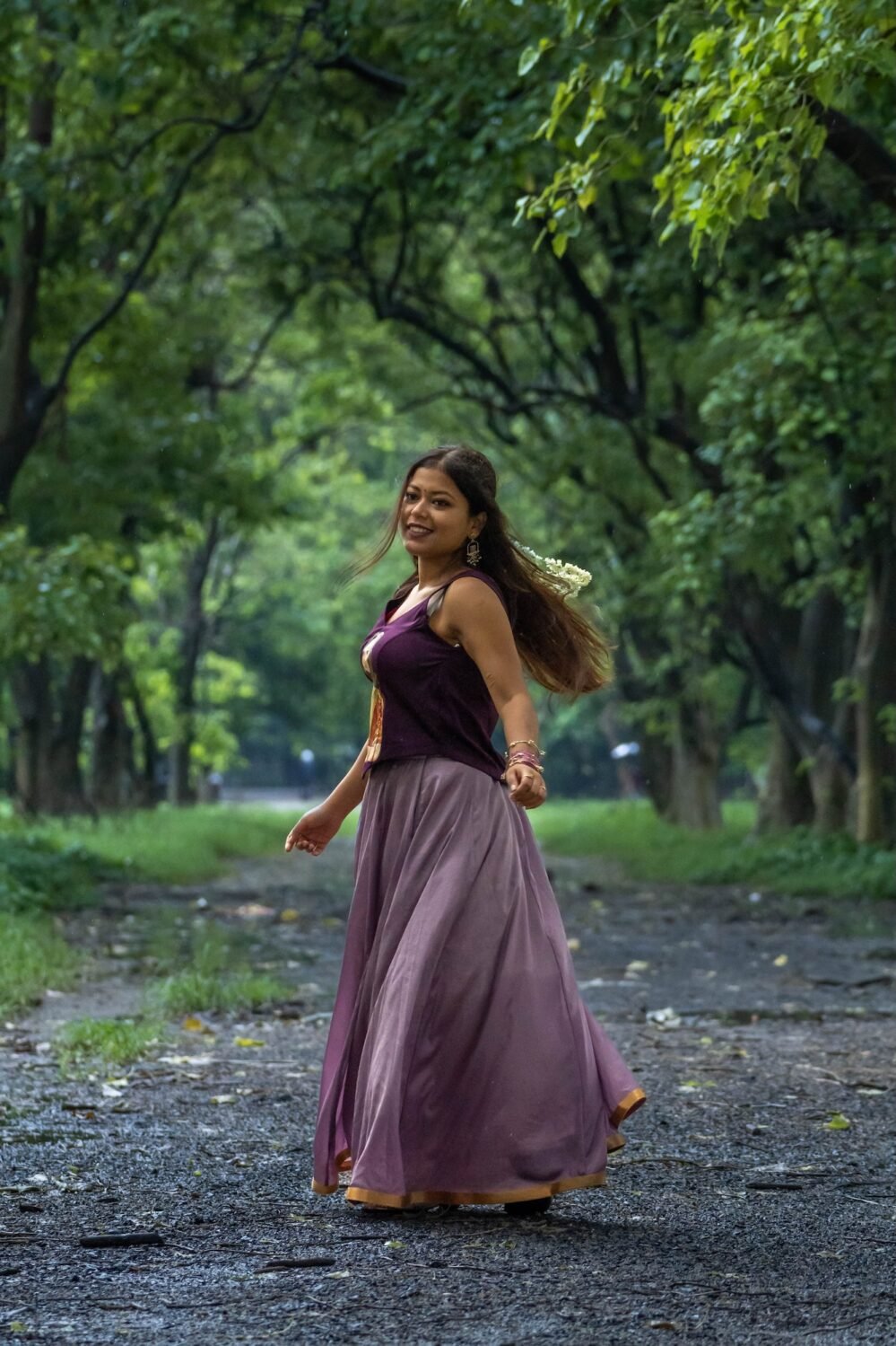 Outdoor shoot of a model twirling in the Kalyani flowy lehanga skirt by Aankibukis Couture.