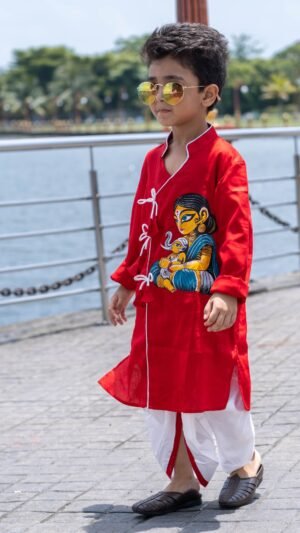 Boy walking outdoors wearing red hand painted Maa Ganna angrakha kurta with off white ready to wear dhoti set by Aankibukis Couture