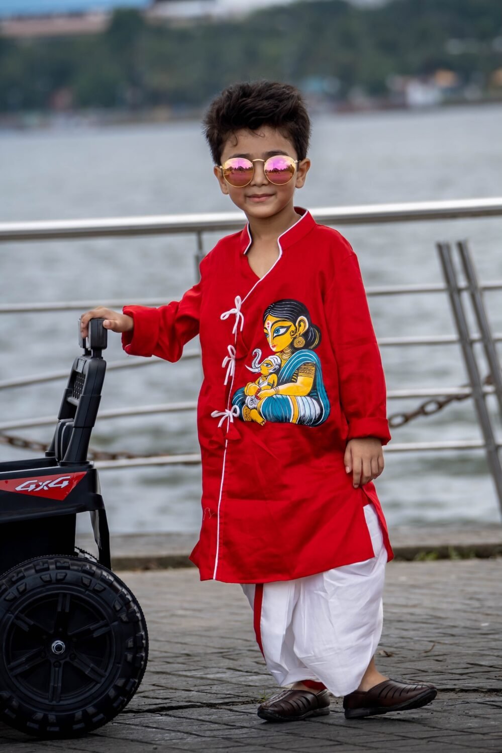 Boy posing next to a toy car wearing ready to wear hand painted cotton dhoti kurta set for kids festival wear