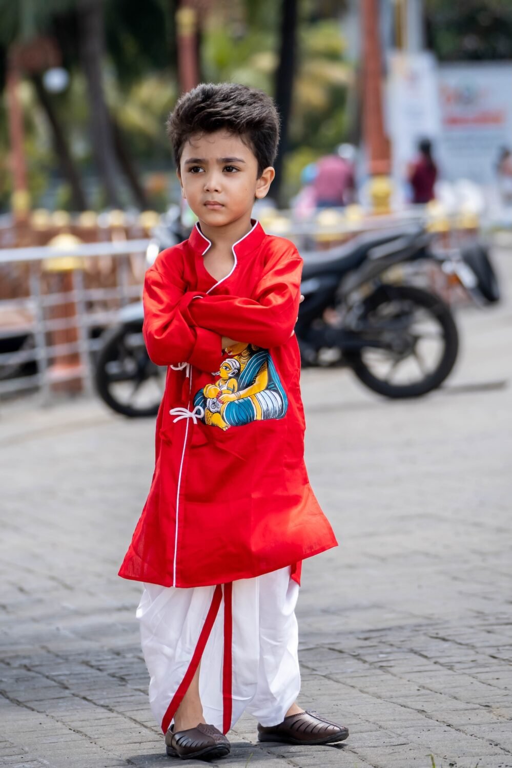 Front pose of boy wearing red cotton hand painted Maa Durga Ganesha angrakha kurta set with white piping and side ties