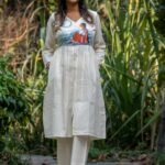 Full-length front view of handpainted off-white kora khadi tunic and matching straight pants set.