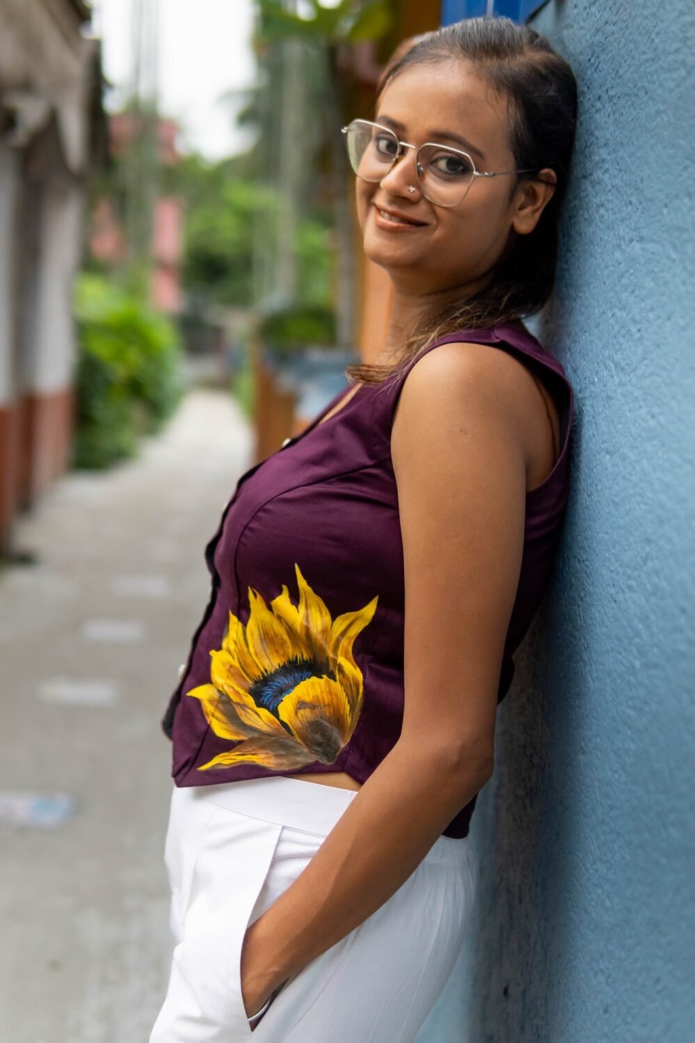 Side view showing the detailed sunflower artwork on a purple cotton waist coat designed for office wear.