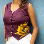 Three-quarter view of a woman styled in a deep purple handpainted sunflower Malai cotton waist coat.