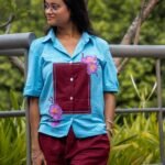 Medium shot showing the handpainted 3D orchid flowers, maroon chest patch, and matching pant design on the Sky Blue Maroon Orchid set.