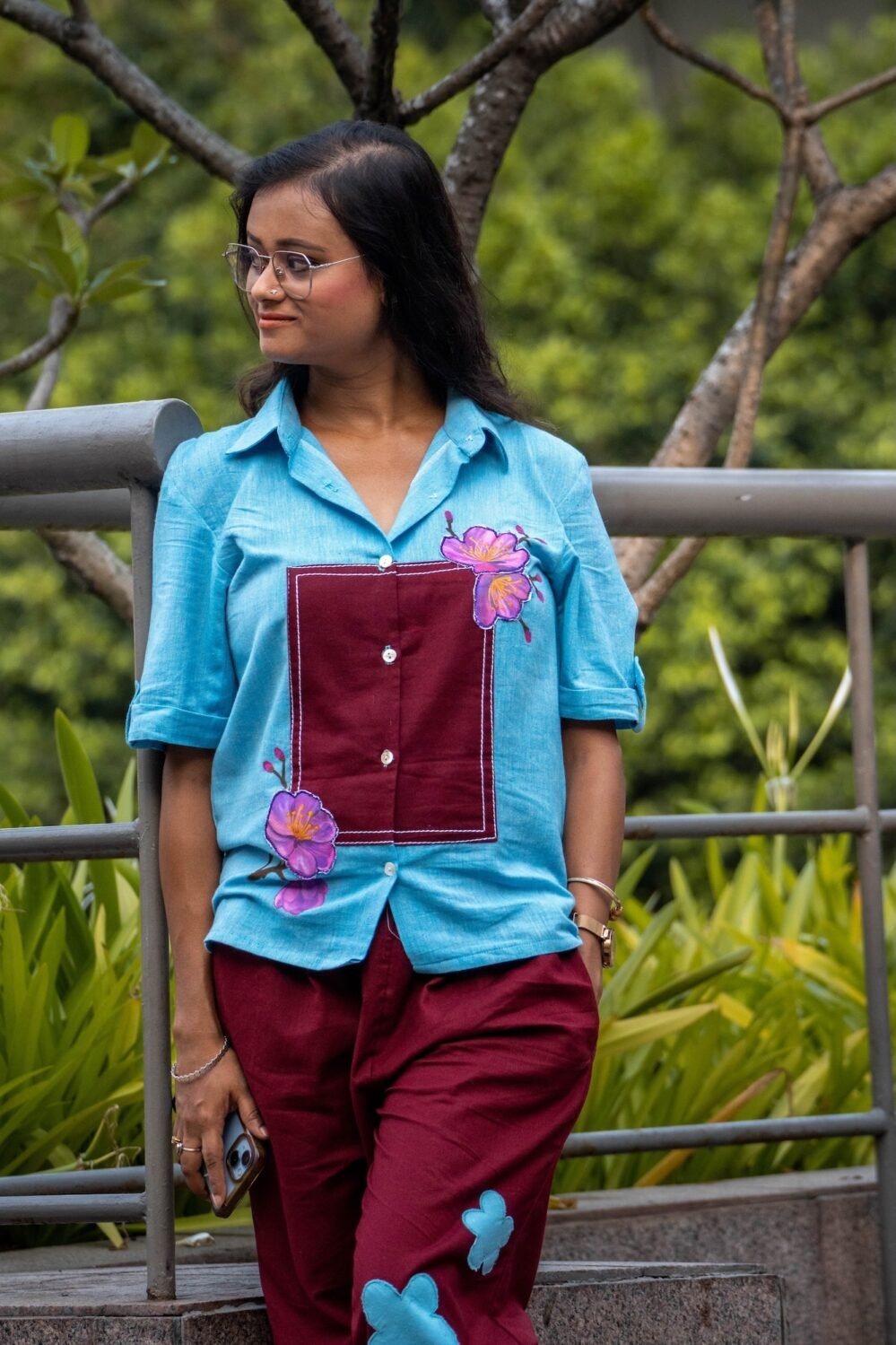 Medium shot showing the handpainted 3D orchid flowers, maroon chest patch, and matching pant design on the Sky Blue Maroon Orchid set.