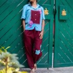 Lifestyle shot of a woman wearing the Sky Blue Maroon Orchid handpainted 3D cotton co-ord set by Aankibukis Couture.