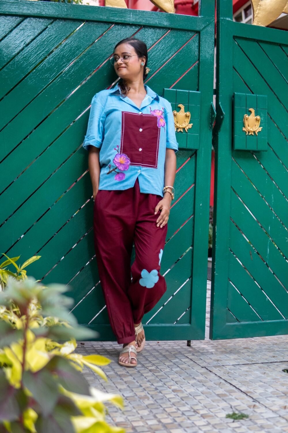 Lifestyle shot of a woman wearing the Sky Blue Maroon Orchid handpainted 3D cotton co-ord set by Aankibukis Couture.