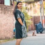 side look of a hand painted batik dress, standing in the middle of road