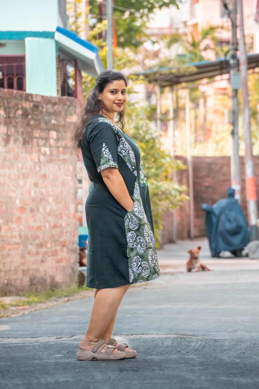side look of a hand painted batik dress, standing in the middle of road