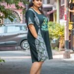 women wearing handpainted boat and lotus motif mid length dress with batik patch, side look