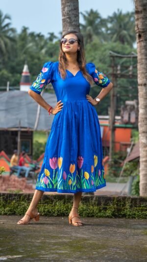 Woman in sunglasses posing in a hand-painted royal blue tulip dress by Aankibukis Couture.