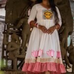 Front view of the off-white Annapurna dress featuring hand-painted Maa Durga on the bodice and lotuses on the hem.