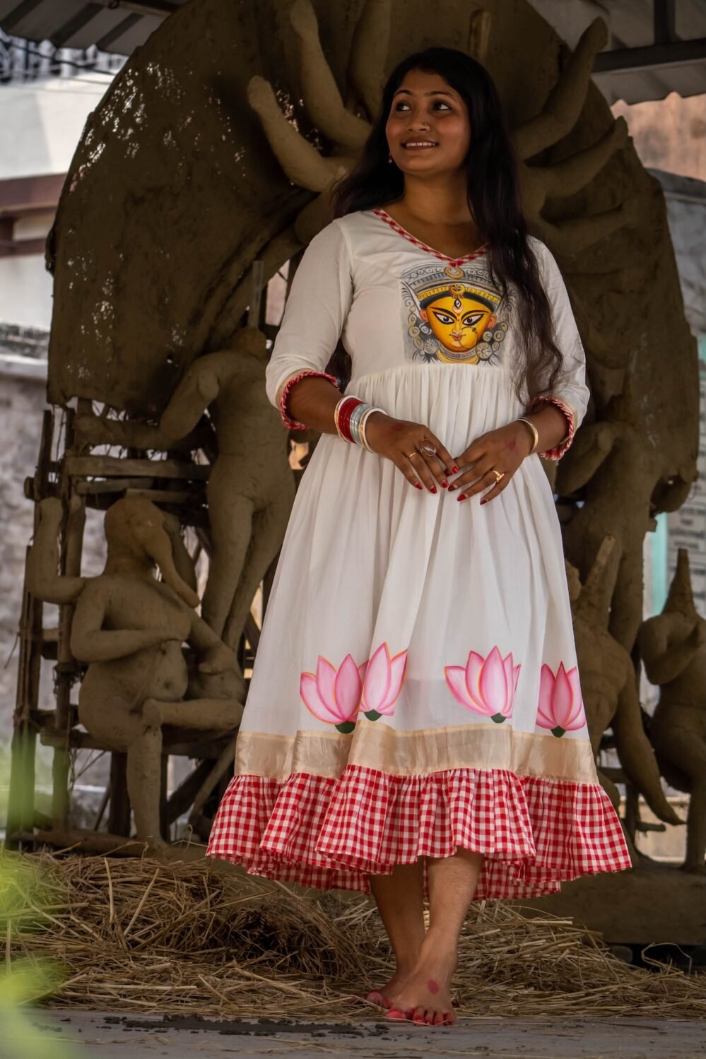 Front view of the off-white Annapurna dress featuring hand-painted Maa Durga on the bodice and lotuses on the hem.