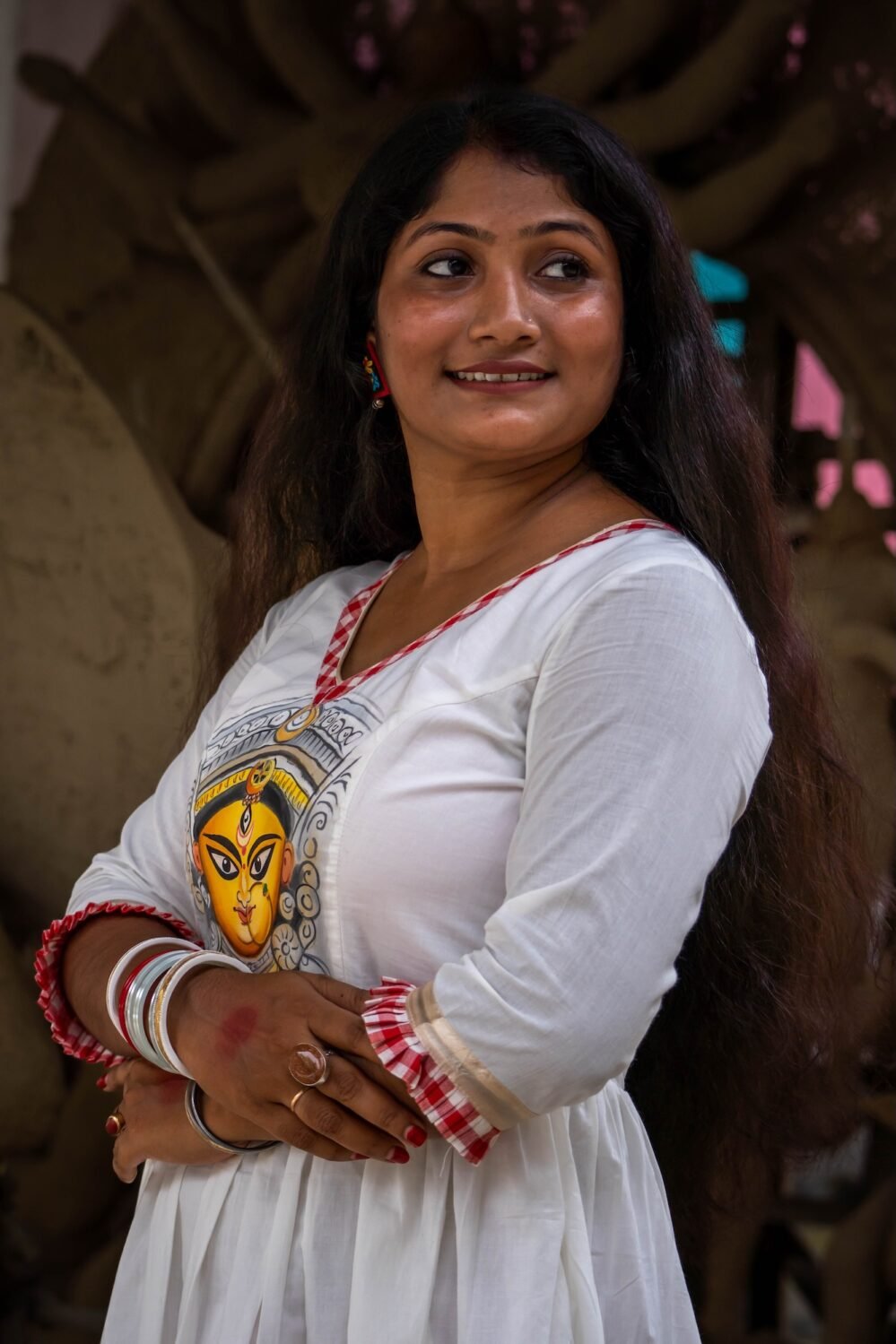 ortrait of a woman showcasing the hand-painted Maa Durga artwork on the bodice of the Annapurna dress.