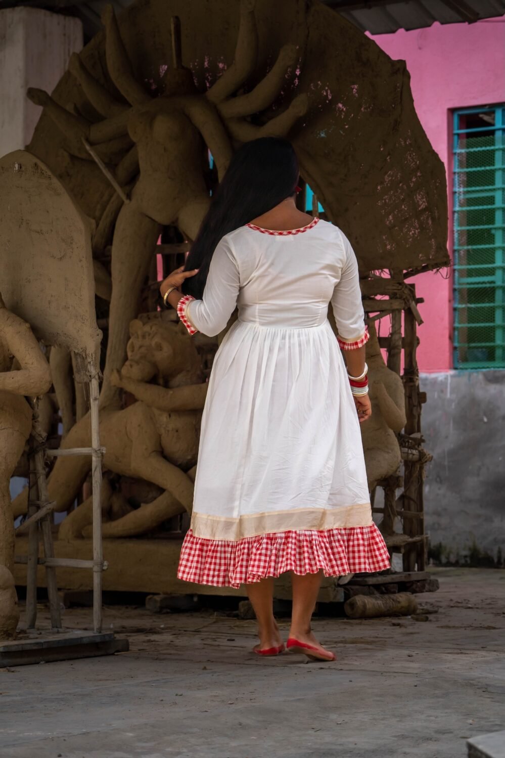 Back view of the off-white Annapurna cotton dress showing the V-neckline piping and gamcha ruffle hem.