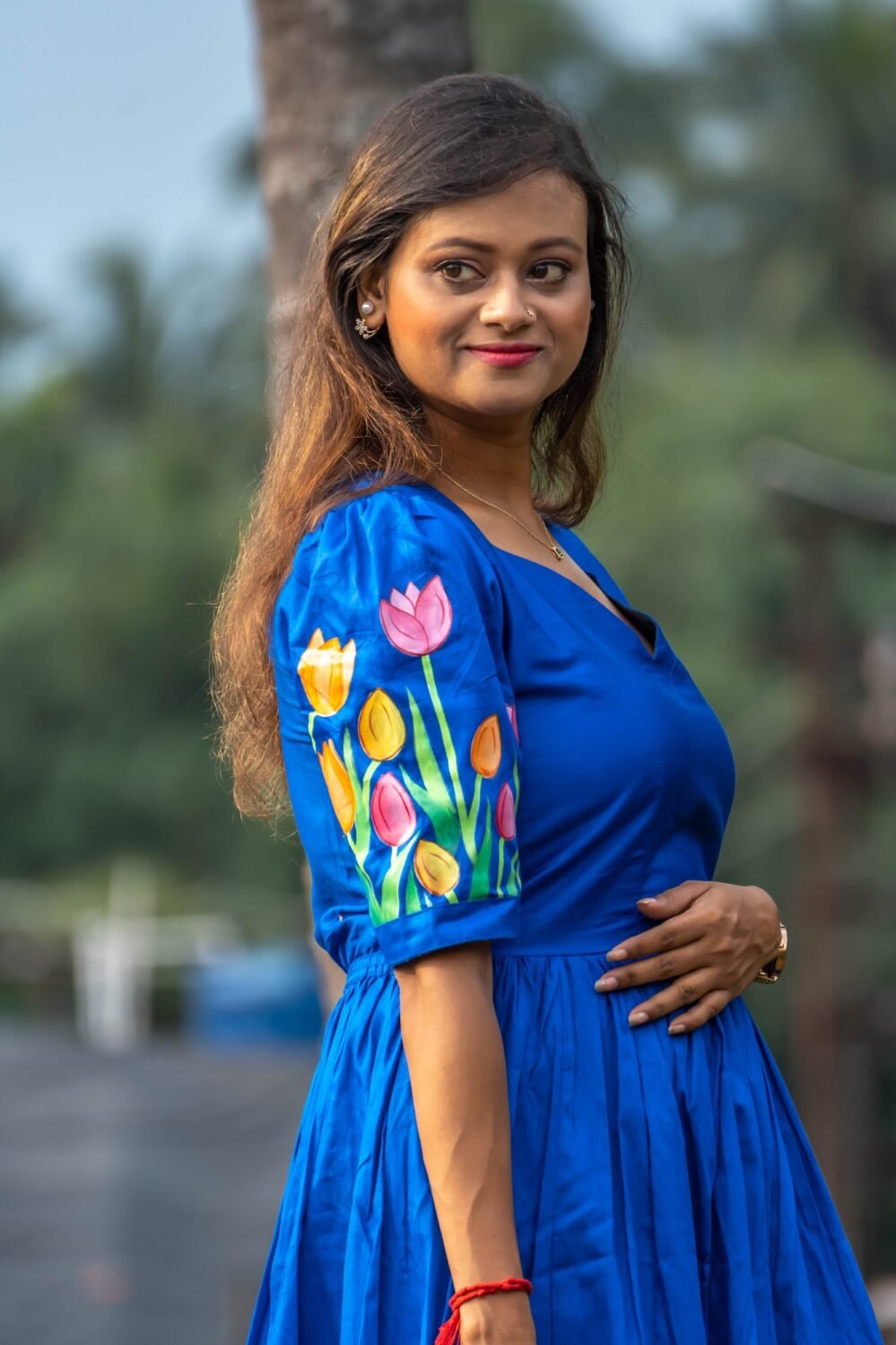 Close-up of the sweetheart neck bodice and hand-painted tulip sleeves on a royal blue dress.