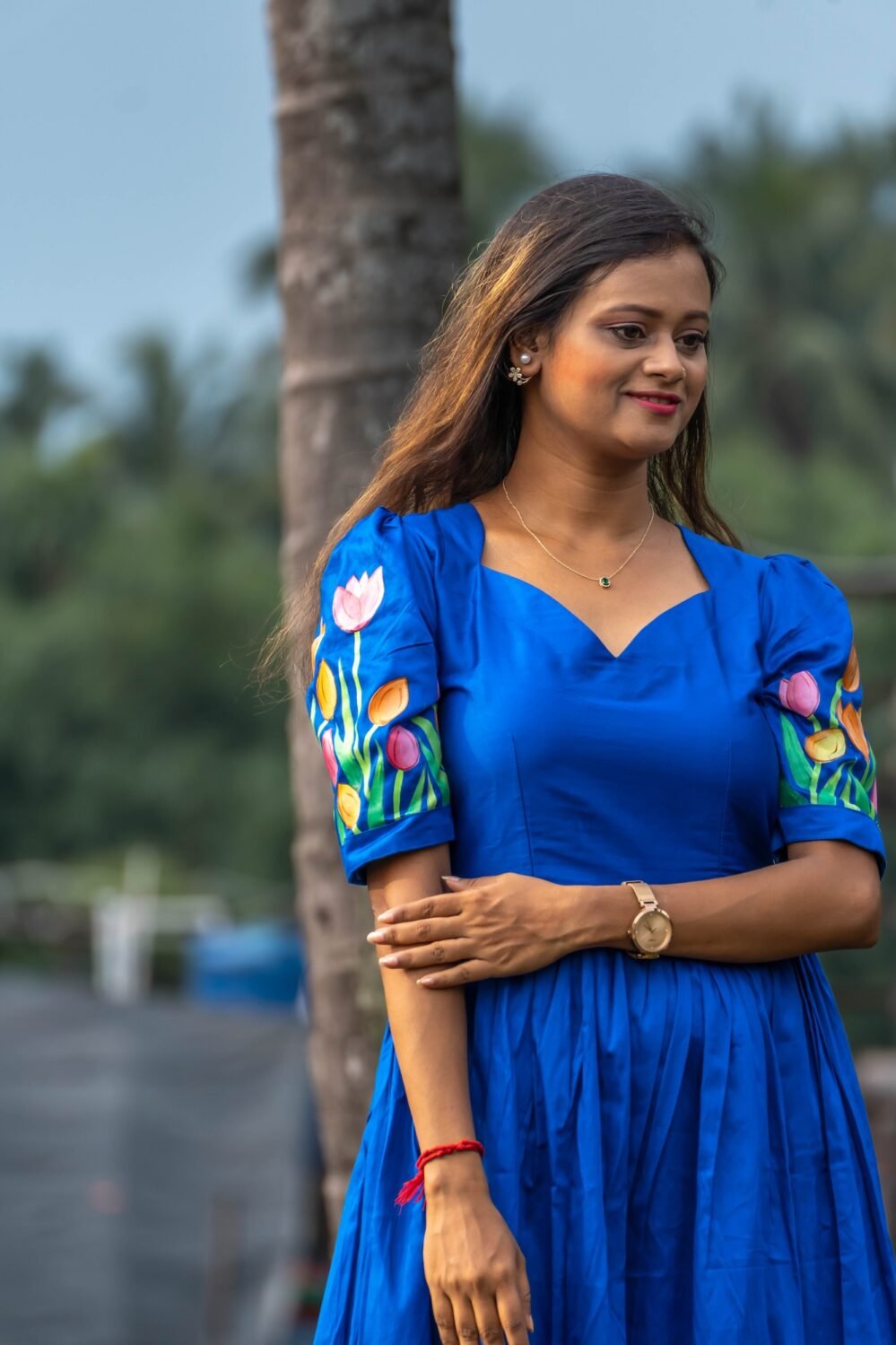 Close-up of the sweetheart neck bodice and hand-painted tulip sleeves on a royal blue dress.
