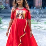 Front view of model standing in red malai cotton gown with central hand-painted Maa Durga motif.